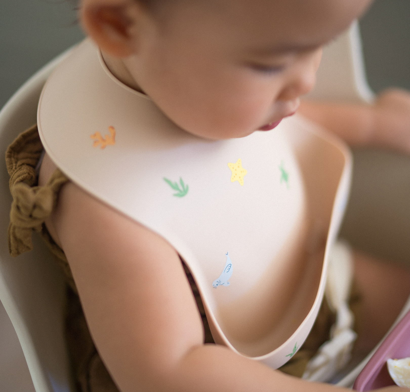 Baby wearing Ava and Oliver Silicone Bib Hawaiian Sea Animals