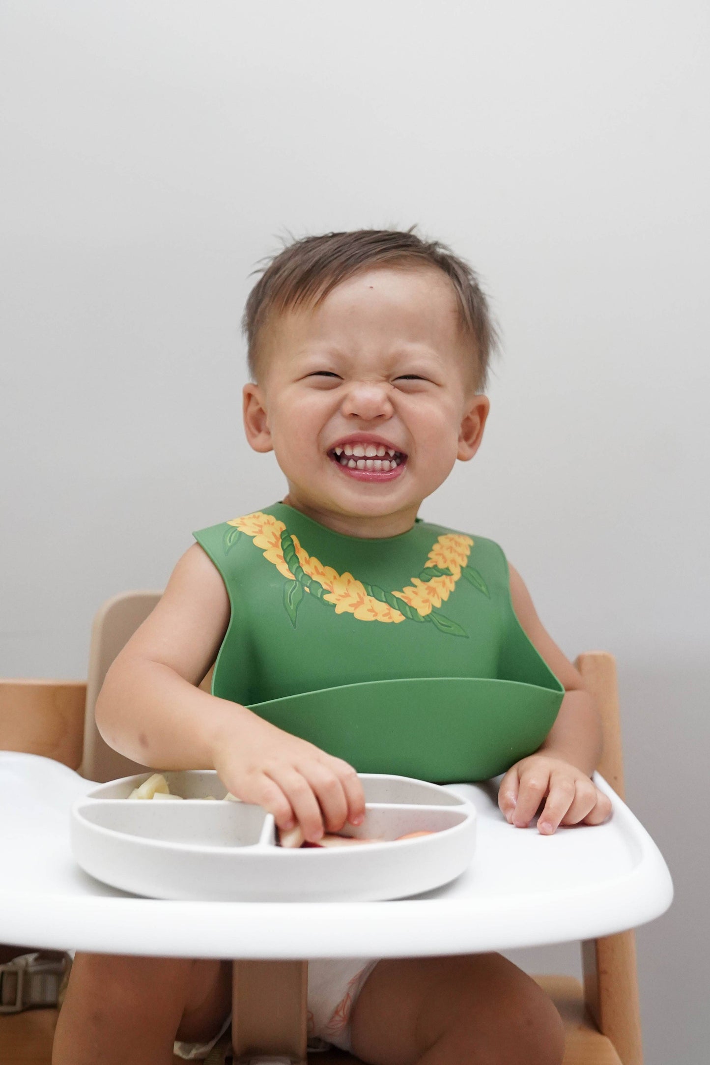 Baby wearing Ava and Oliver Silicone Bib Ilima Lei