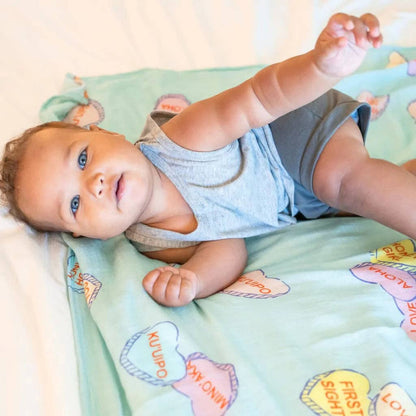 Baby on Coco Moon I Lava You Muslin Swaddle
