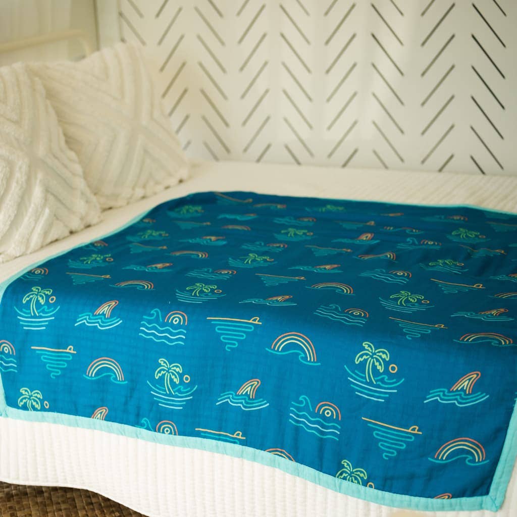 Coco Moon Tropical Daydream Baby Quilt on bed