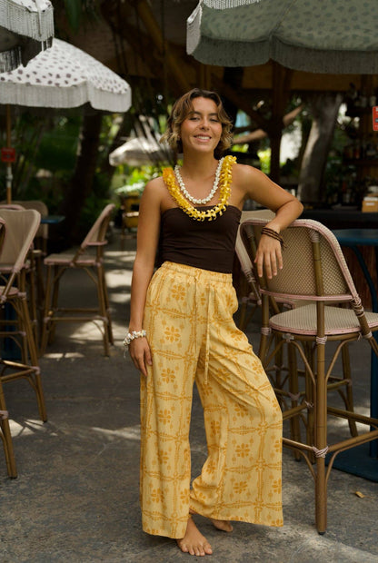 Person wearing EHA Culture Pua Kenikeni Glow Hoa Pants