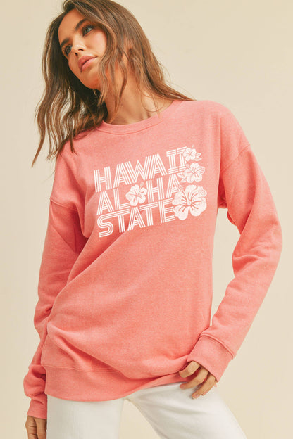 Person wearing Honestee Hawaii Aloha State Graphic Sweatshirt (pink)