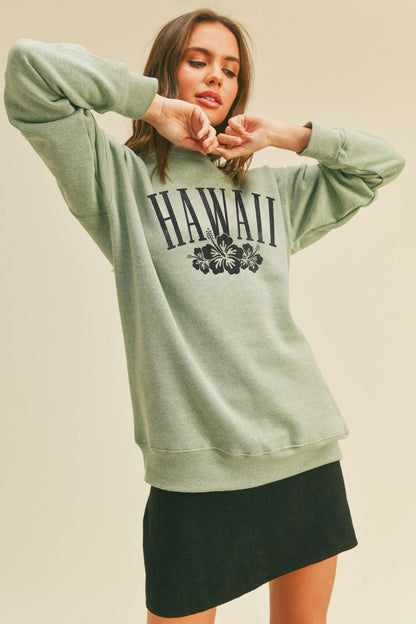 Person wearing Honestee Hawaii Flowers Graphic Sweatshirt (light green)