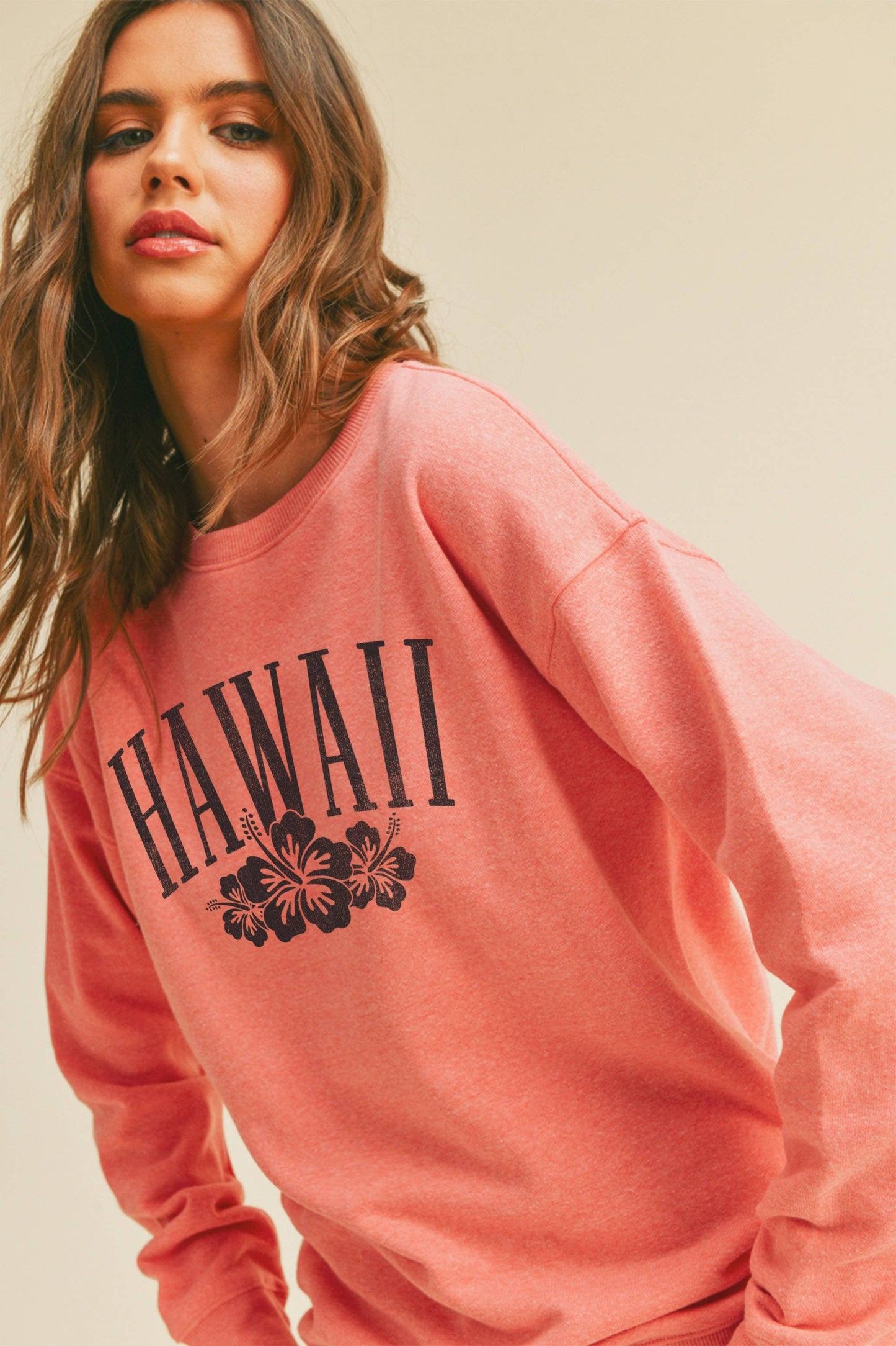 Person wearing Honestee Hawaii Flowers Graphic Sweatshirt (pink)