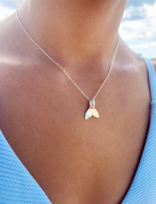 Person wearing Ki Ele Ka’ena Whale Tail Pendant necklace