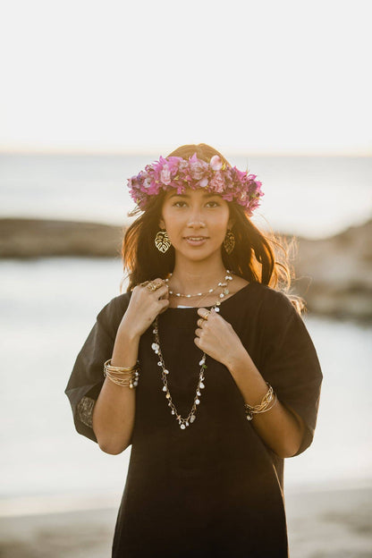 Person wearing Ki Ele Medium Monstera Statement Drop Earrings