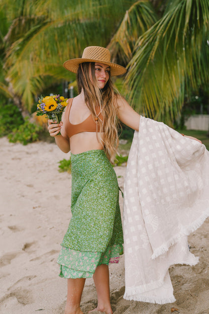 Person holding EHA Culture Magnolias & Gingham Luxurious Beach Towel